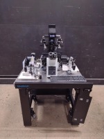 OLYMPUS IX73 LAB MICROSCOPE WITH 5 OBJECTIVES AND EYE PIECES 10X/22, WITH NARUSHIGE, NARISHIGE EQUIPMENT, DELL D15U PC, RI SATURN 5 ACTIVE LASER SYSTEM ON A CLEAN BENCH TABLE