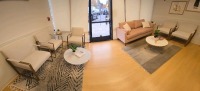 LOBBY FURNITURE TO INCLUDE: 1 SOFA, 5 ARM CHAIRS, 2 COFFEE TABLES, 2 END TABLES, 2 RUGS, WITH PLANTS AND BOOKS