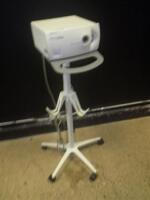 WELCH ALLYN CL 100 LIGHT SOURCE WITH HEADSET ON ROLLING STAND