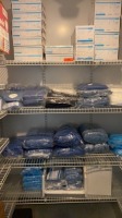 LOT OF DISPOSABLE PPE ON SHELVES