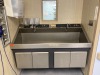 AMSCO DOUBLE BASIN, KNEE OPERATED SCRUB SINK (THIS LOT REQUIRES PROFESSIONAL DE-INSTALLATION AND CERTIFICATE OF INSURANCE)